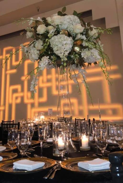 Beautiful white floral centerpiece with hydrangeas and roses for wedding receptions.
