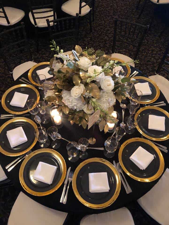 Beautiful floral centerpiece with white roses and greenery for wedding reception at Paradise Ballroo.