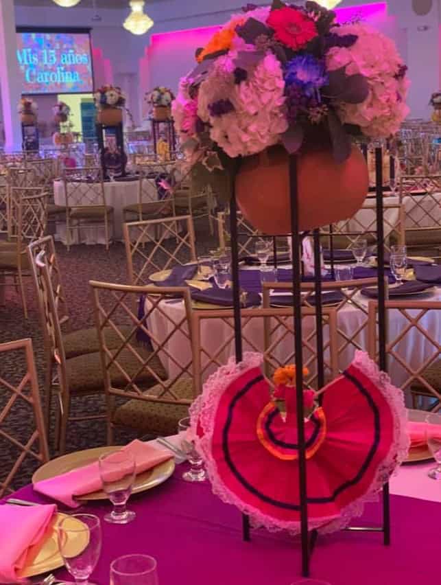Floral centerpiece with pink and purple flowers at Paradise Ballrooms event.