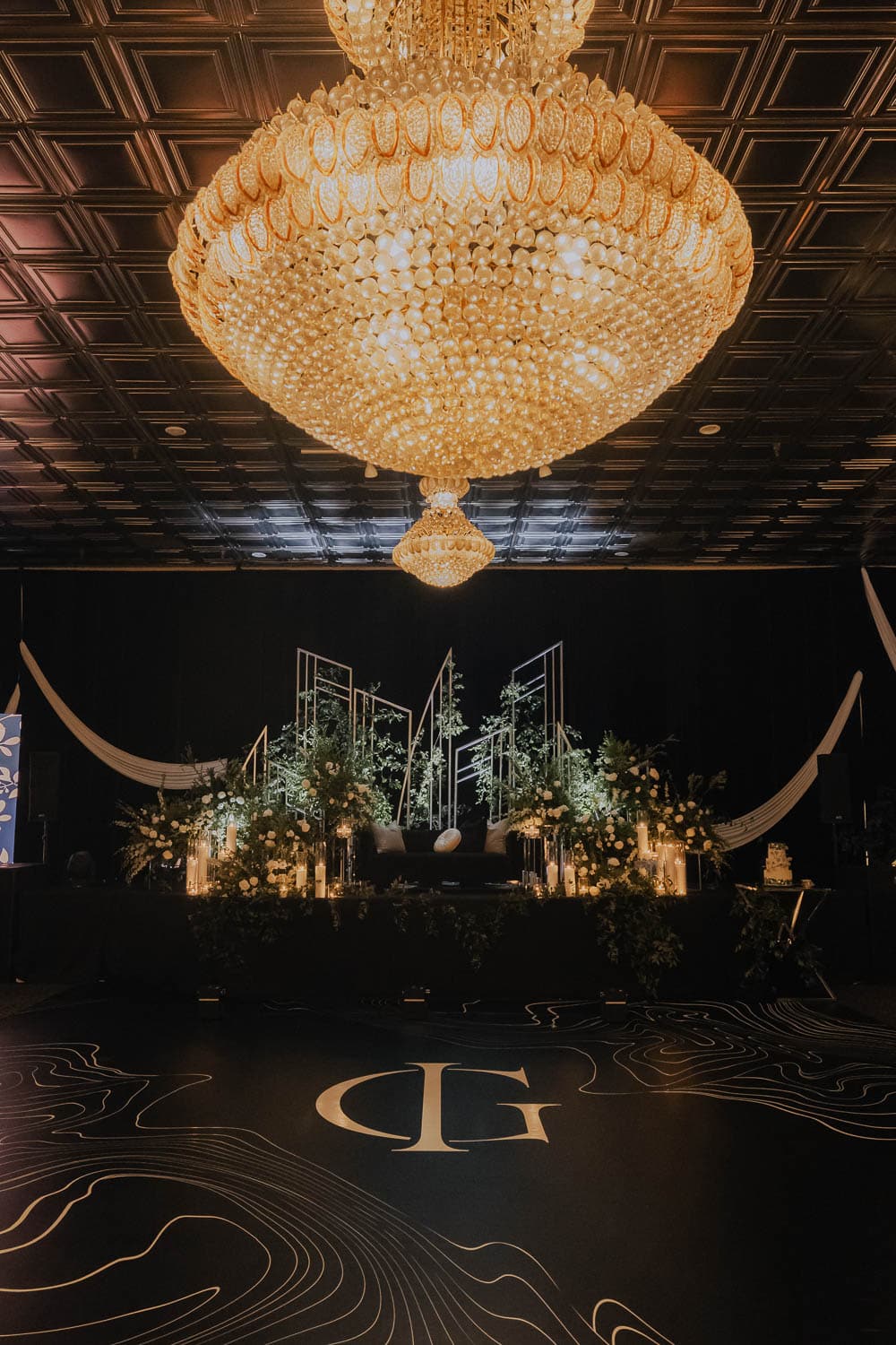 Chandelier and luxurious decor in a grand ballroom setting.