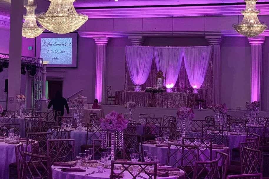 Elegant event space with purple lighting and luxurious decor for weddings and parties.